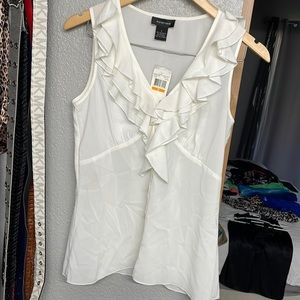 Ivory colored ruffle blouse by Spense . New w/ tags. Size small